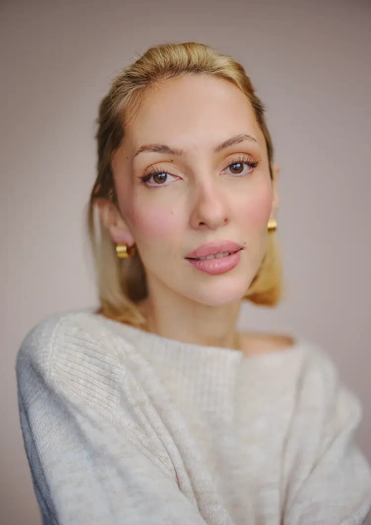 Daylight actor headshot of Rosie Lou seated against a pink canvas backdrop, photographed on medium format
